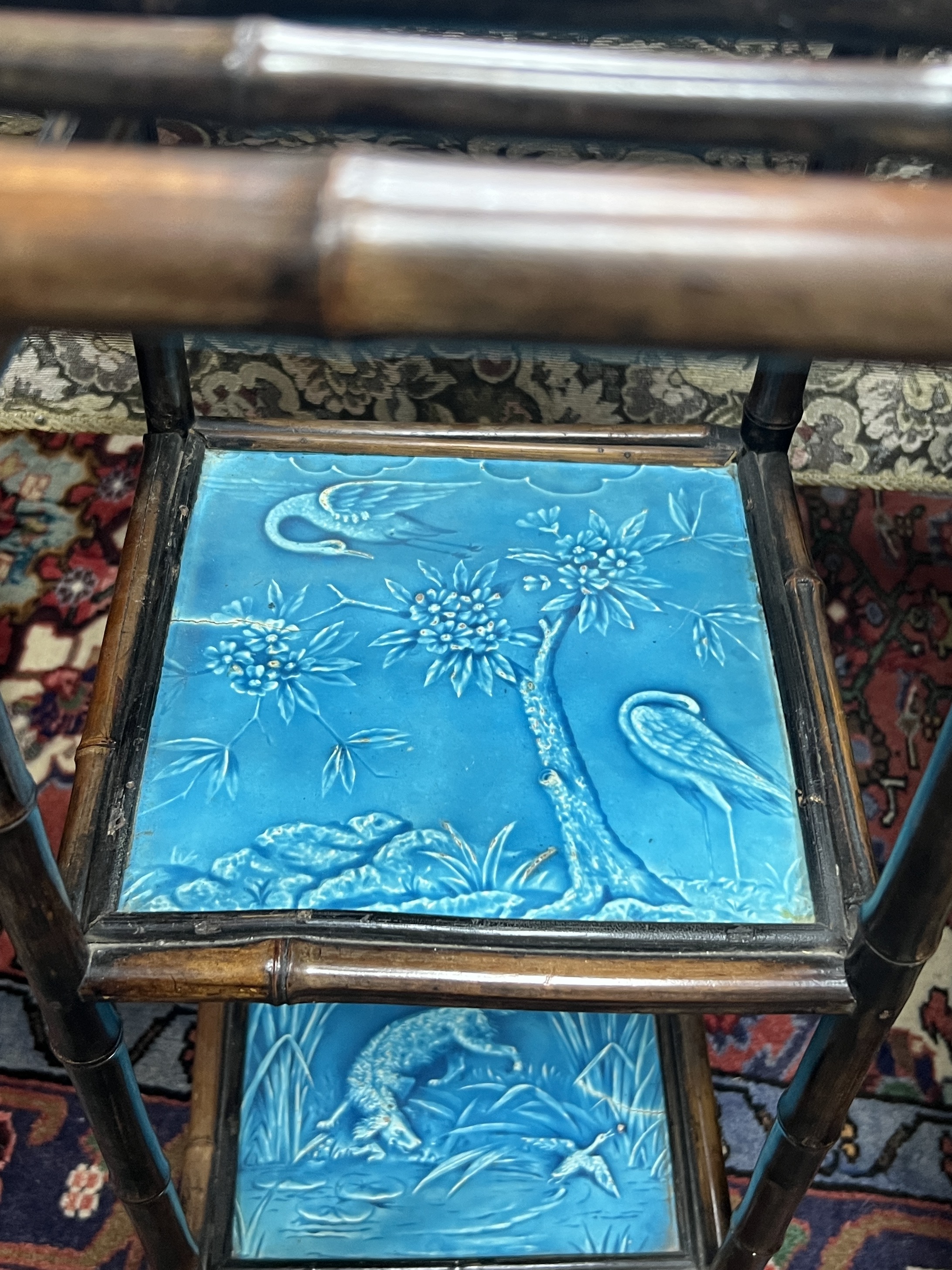 A Victorian Aesthetic movement bamboo and Minton tile inset three tier stand, width 38cm, height 76cm